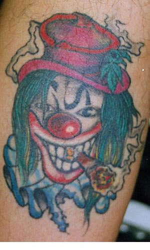Bad clown with cigar tattoo